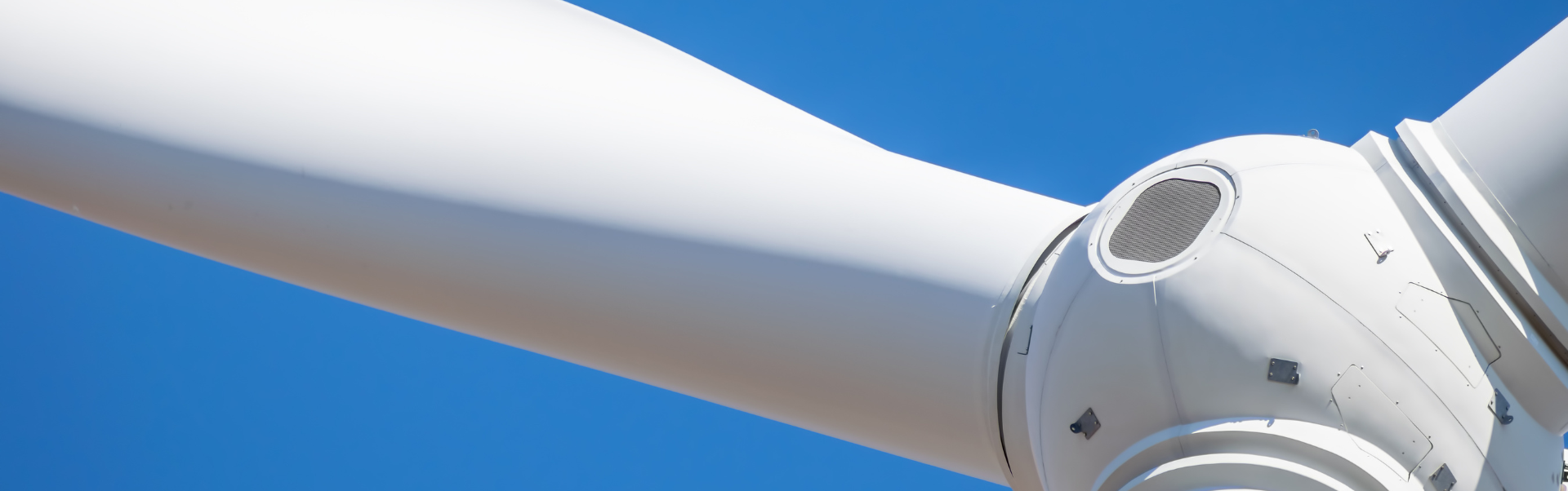 Technical close-up of wind turbine hub and blade for structural risk analysis and integrity assessment